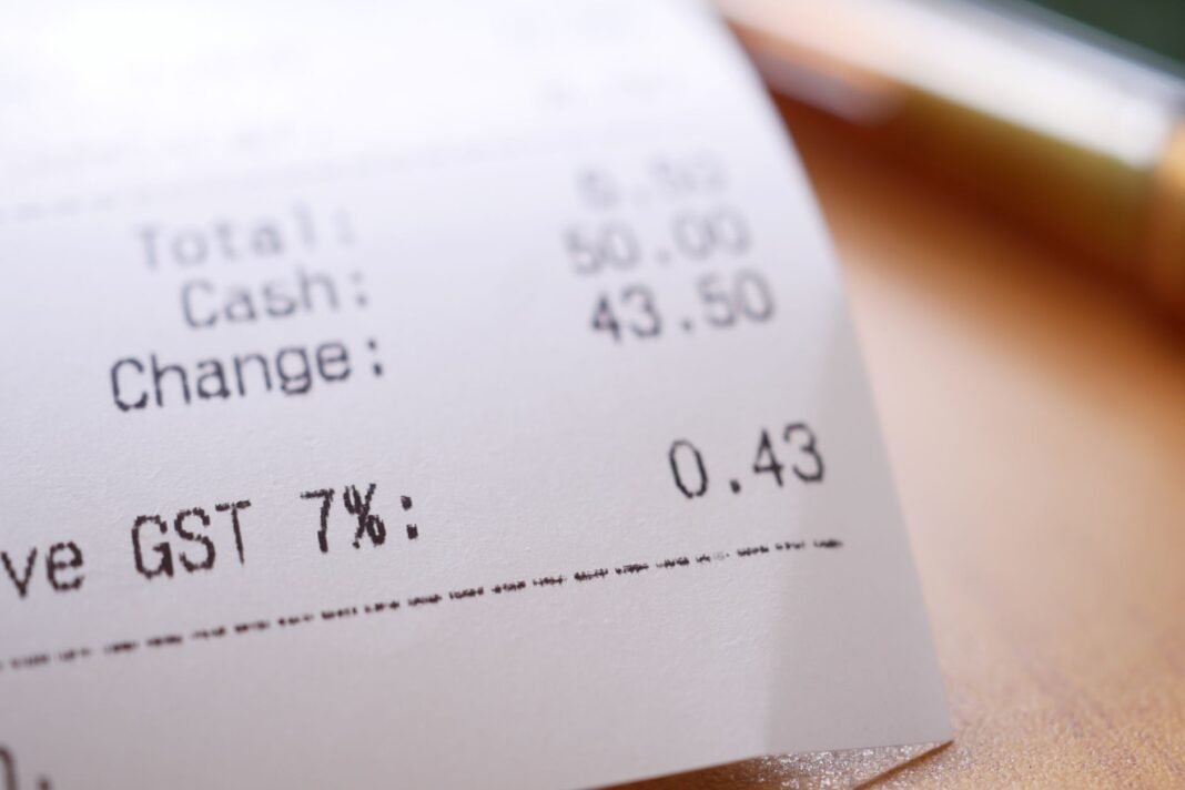 One year after GST rate rejig, rising commodity prices erode consumer savings Detailed close-up image of a shopping receipt showing GST and total changes.