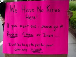 A vibrant protest sign in South Kingstown, Rhode Island, advocating against monarchies with political messaging.